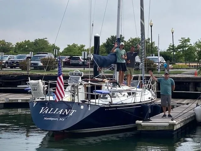 Slide: The Image of 1988 C&C 41 sailboat "Valiant" docked in Northport, NY with crew waving. - 11