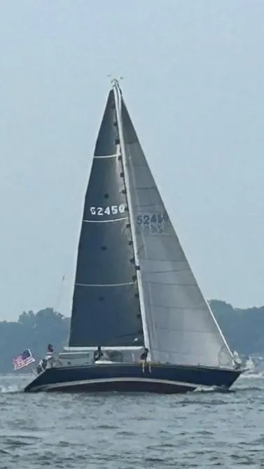 Slide: The Image of Sailing yacht C&C 41, 1988 model, on open water with American flag. - 14