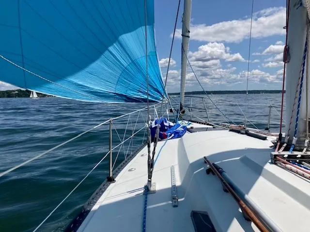 Slide: The Image of Sailing on a 1988 C&C 41 yacht with blue spinnaker under clear skies. - 15