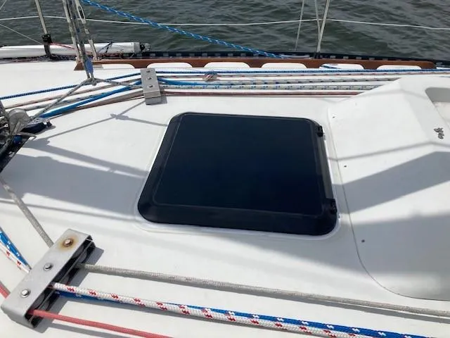 Slide: The Image of 1988 C&C 41 sailboat deck with hatch and colorful rigging ropes. - 21