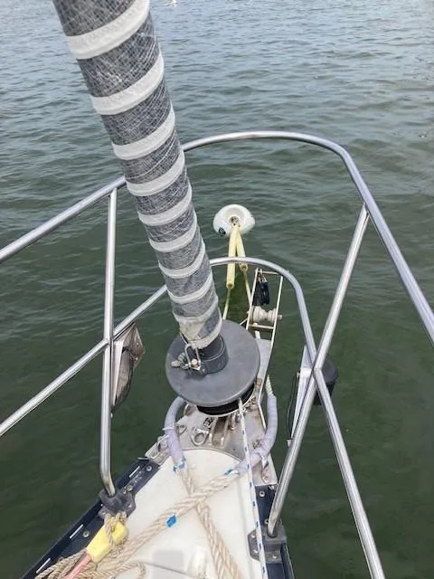 Slide: The Image of Bow of 1988 C&C 41 sailboat with furled sail on calm water. - 27