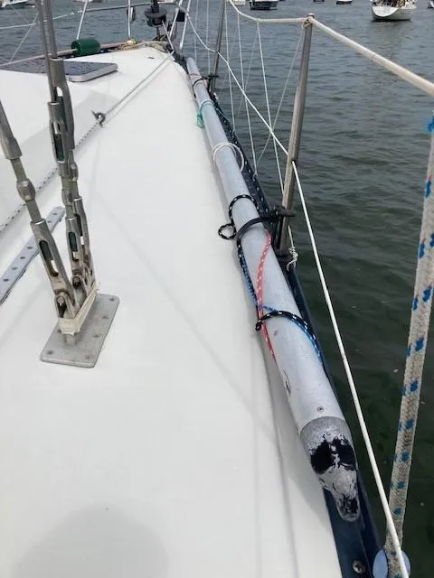 Slide: The Image of 1988 C&C 41 sailboat deck with rigging, moored in calm waters. - 28