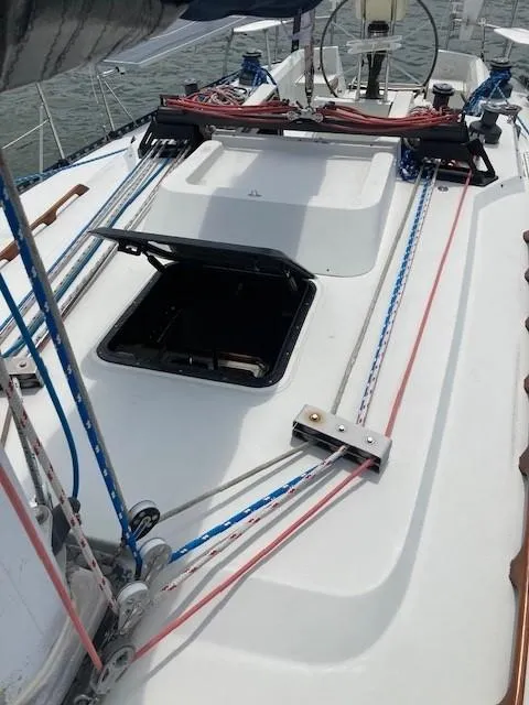Slide: The Image of 1988 C&C 41 sailboat deck with open hatch and colorful rigging lines. - 30