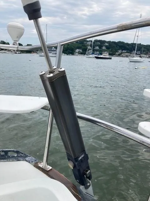 Slide: The Image of Close-up of a 1988 C&C 41 sailboat's steering mechanism, with a scenic harbor view. - 38