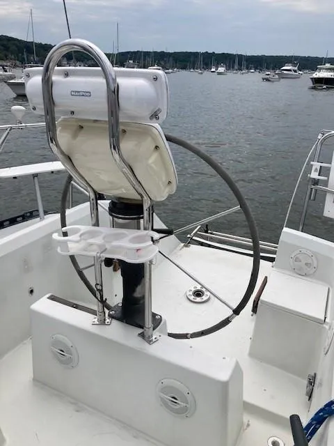 Slide: The Image of 1988 C&C 41 sailboat helm with wheel, docked in marina. - 41
