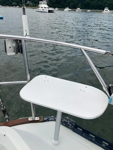 Slide: The Image of 1988 C&C 41 sailboat stern with white table on a calm lake. - 44
