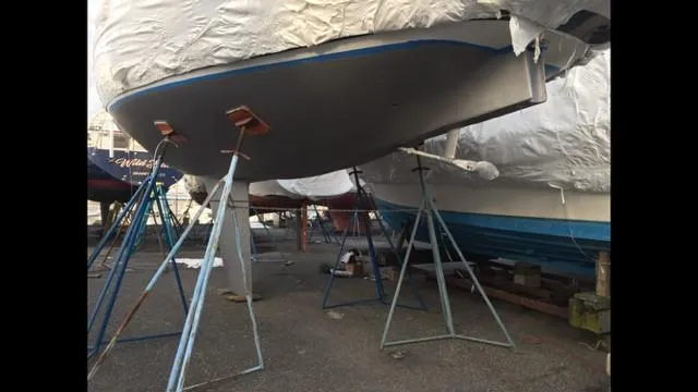 Slide: The Image of 1988 C&C 41 sailboat on stands, covered for maintenance. - 48