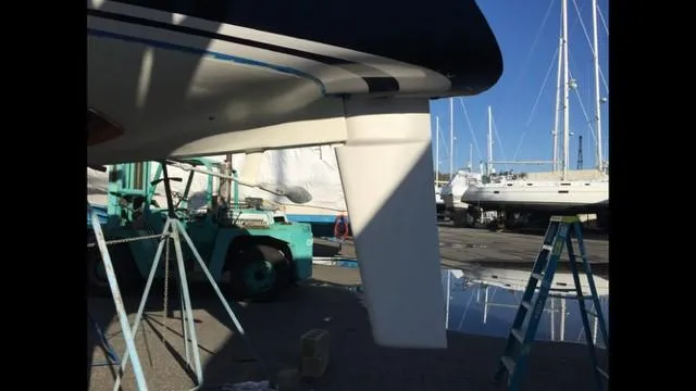Slide: The Image of 1988 C&C 41 sailboat keel in dry dock with maintenance equipment. - 49