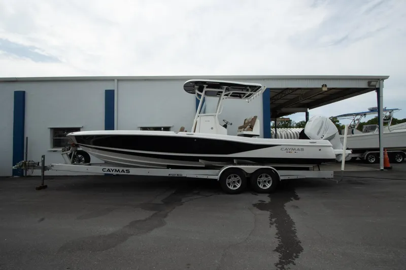 Slide: The Image of 2020 Caymas 28 HB boat on trailer, parked outside a building. - 3