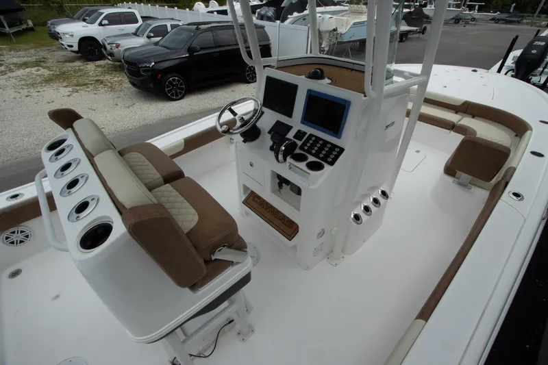 Slide: The Image of 2020 Caymas 28 HB boat interior with helm, seating, and electronics. - 5