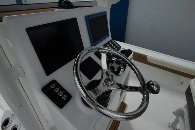 Slide: The Image of 2020 Caymas 28 HB boat dashboard with steering wheel and electronic displays. - 6