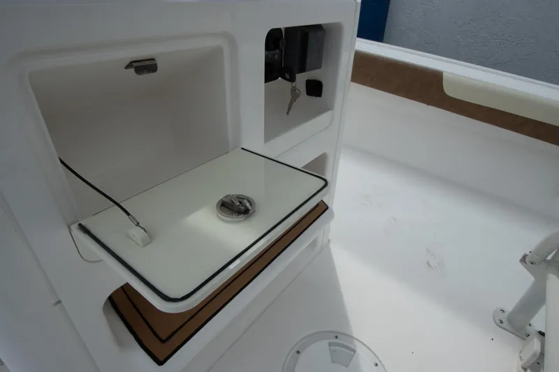 Slide: The Image of 2020 Caymas 28 HB boat interior with storage compartment and key. - 9