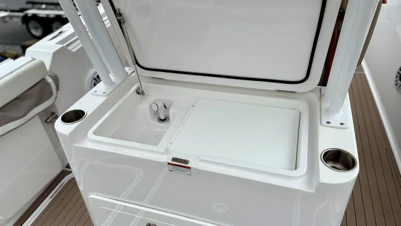 Slide: The Image of 2022 Bertram 28 CC boat sink and storage area with cup holders. - 12