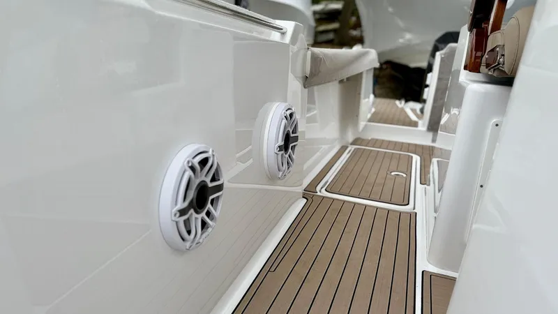 Slide: The Image of 2022 Bertram 28 CC boat interior with sleek design and modern speakers. - 14