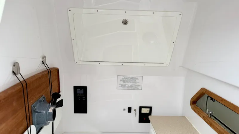 Slide: The Image of Interior of 2022 Bertram 28 CC boat, featuring control panel and storage compartment. - 15