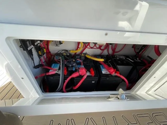 Slide: The Image of Battery compartment of 2022 Bertram 28 CC boat with wiring and connections. - 22