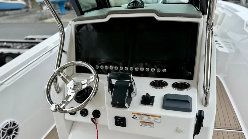 Slide: The Image of 2022 Bertram 28 CC boat console with steering wheel and controls. - 3