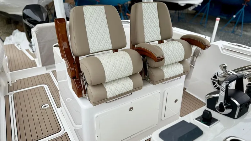 Slide: The Image of Luxury seating on 2022 Bertram 28 CC boat with elegant design and wood accents. - 4