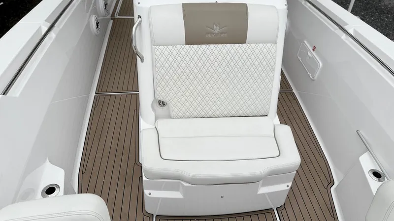 Slide: The Image of 2022 Bertram 28 CC boat interior with white cushioned seating and teak flooring. - 5
