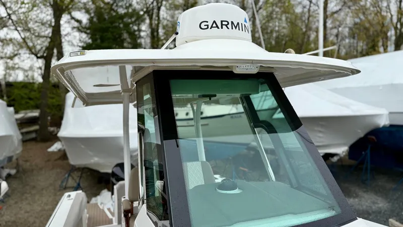 Slide: The Image of 2022 Bertram 28 CC boat with Garmin radar, docked outdoors. - 7