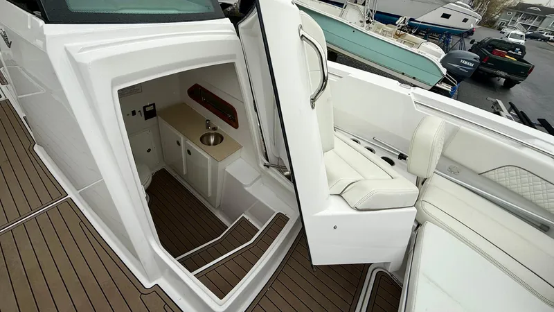 Slide: The Image of 2022 Bertram 28 CC boat interior with seating and compact cabin area. - 8