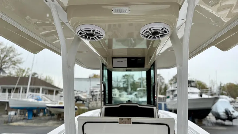 Slide: The Image of 2022 Bertram 28 CC boat interior with speakers and console, docked at marina. - 9