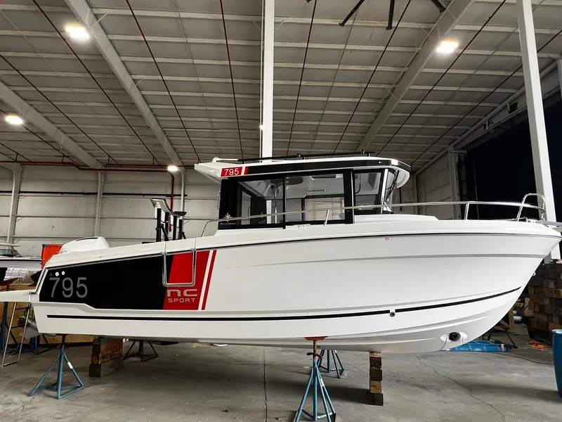The Image of 2025 Jeanneau 795 SPORT S2 boat in a warehouse, side view. - 0