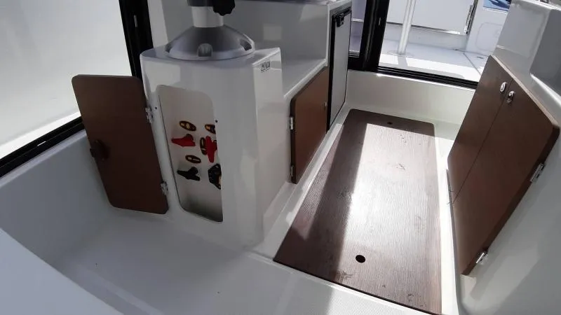 Slide: The Image of Interior of 2025 Jeanneau 795 SPORT S2 boat, featuring storage compartments and sleek design. - 16