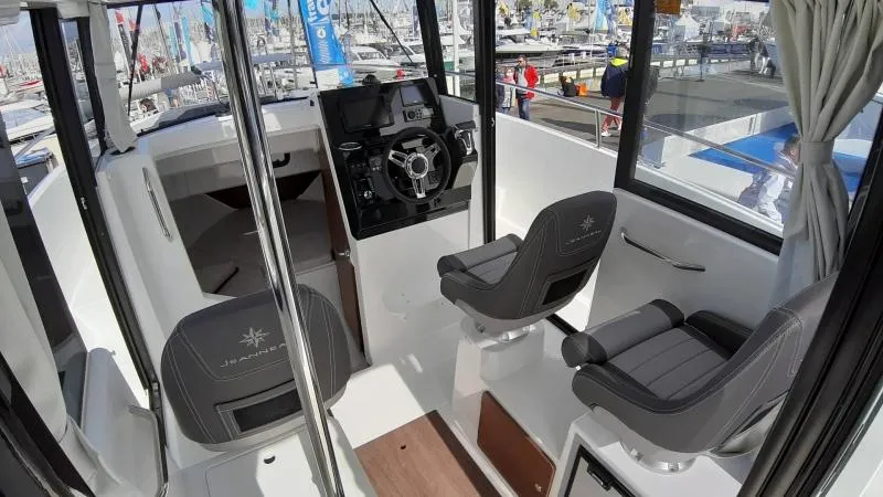 Slide: The Image of Interior of 2025 Jeanneau 795 SPORT S2 boat with modern seating and controls. - 18