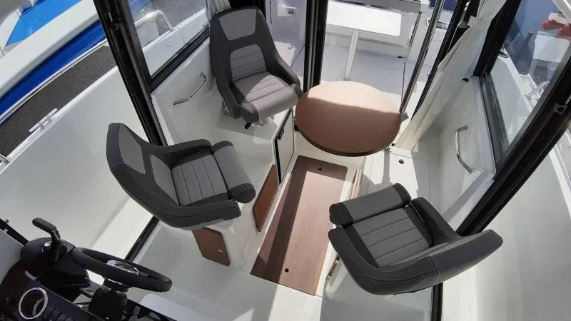 Slide: The Image of Interior of 2025 Jeanneau 795 SPORT S2 boat with modern seating and table. - 19