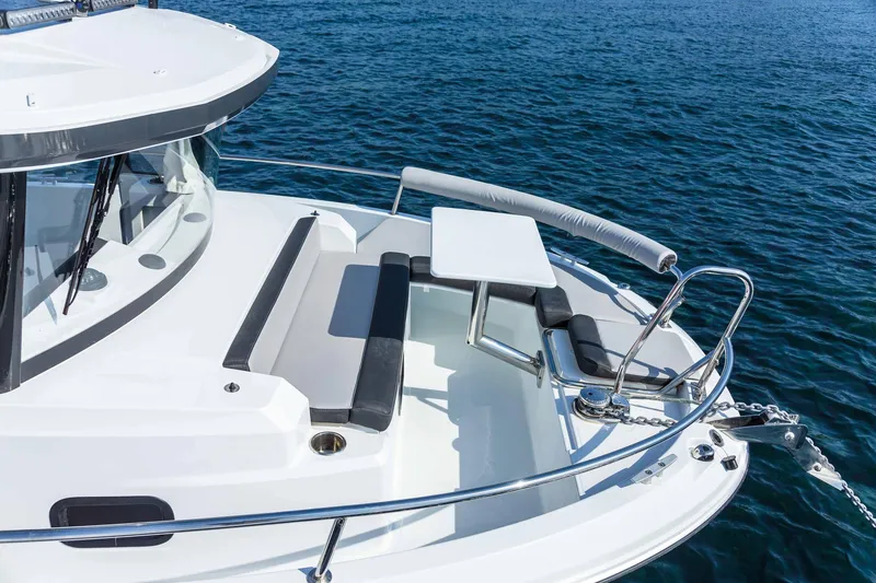 Slide: The Image of 2025 Jeanneau 795 SPORT S2 boat with seating area on calm water. - 2