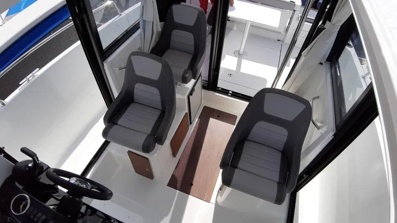 Slide: The Image of Interior of 2025 Jeanneau 795 SPORT S2 boat with three modern seats. - 21