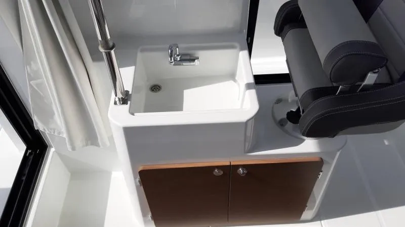 Slide: The Image of Interior of 2025 Jeanneau 795 SPORT S2 boat with sink and seating area. - 14