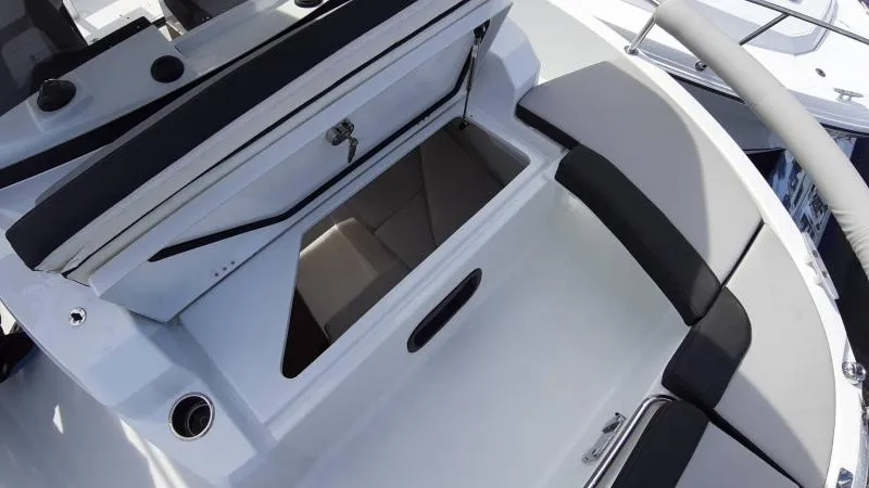 Slide: The Image of 2025 Jeanneau 795 SPORT S2 boat interior storage compartment with cushioned seating. - 6