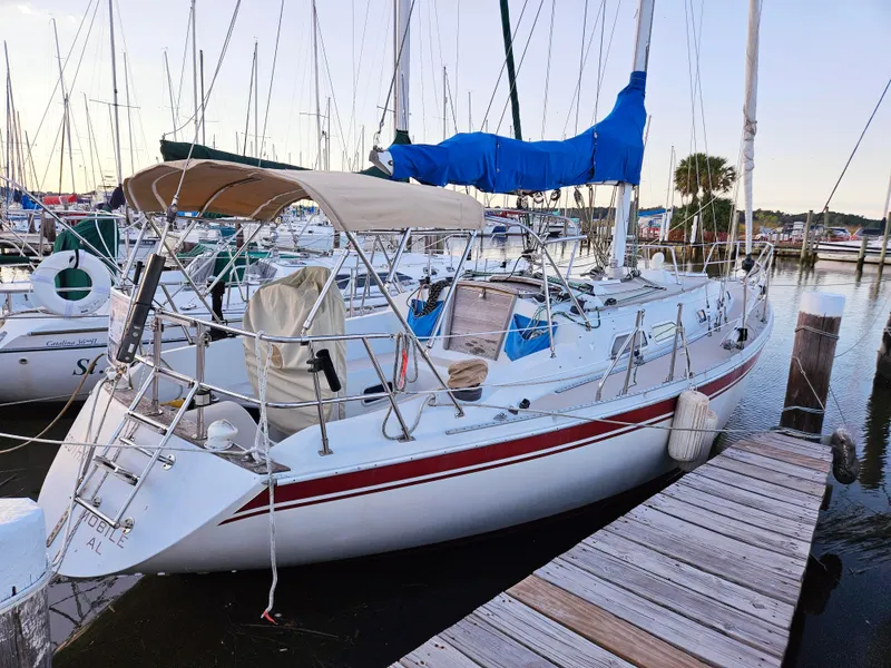 The Image of 1989 Ericson 35 MKIII sailboat docked at marina with blue sail cover. - 0