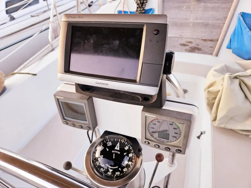 Slide: The Image of Cockpit navigation instruments on 1989 Ericson 35 MKIII sailboat, featuring Garmin GPS and compass. - 14