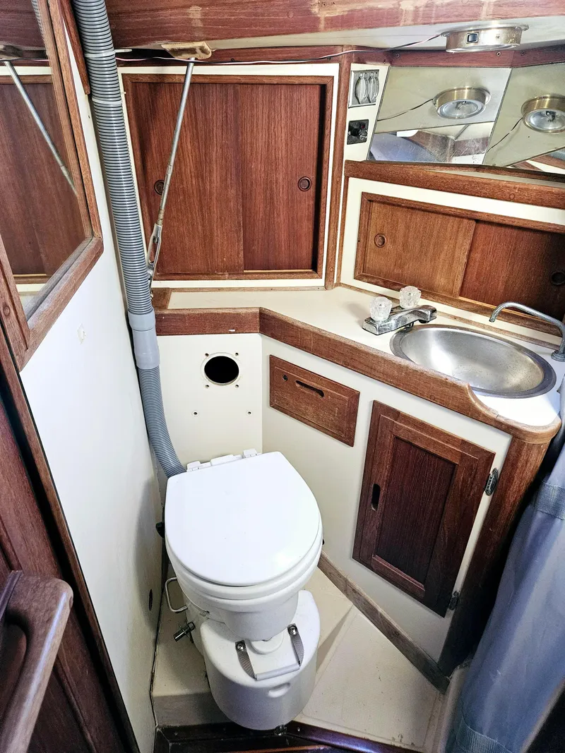 Slide: The Image of 1989 Ericson 35 MKIII yacht bathroom with wooden cabinets and stainless steel sink. - 44