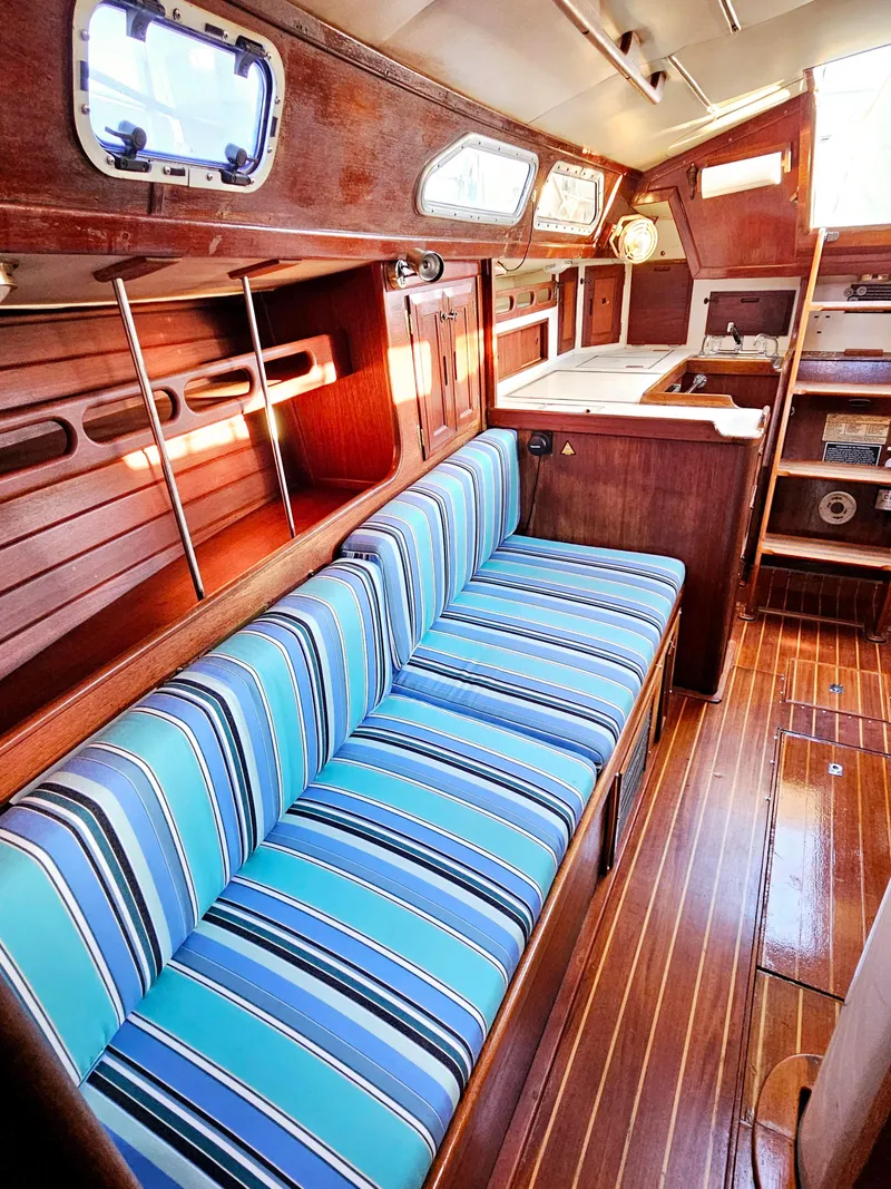 Slide: The Image of Interior of 1989 Ericson 35 MKIII sailboat with striped cushions and wooden finishes. - 46