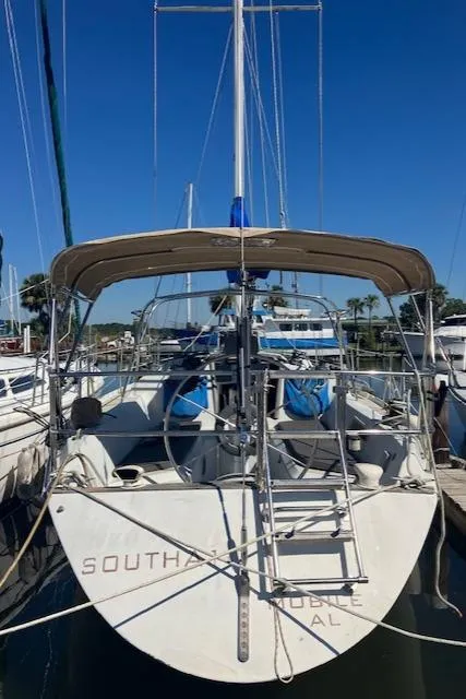 Slide: The Image of 1989 Ericson 35 MKIII sailboat docked, featuring a spacious deck and sleek design. - 5