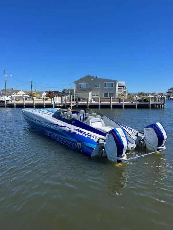 Slide: The Image of 2022 Mystic Powerboats C4000 in water, featuring sleek design and powerful engines. - 11