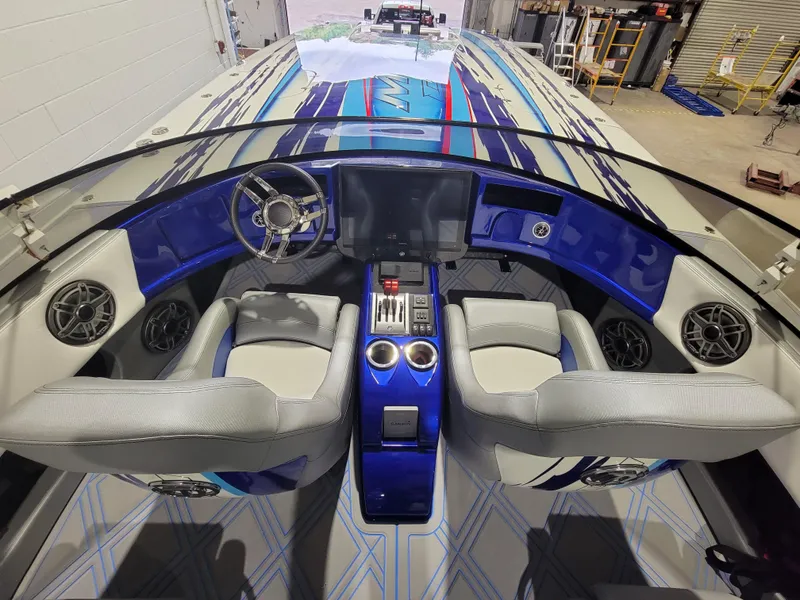 Slide: The Image of Interior view of 2022 Mystic Powerboats C4000 cockpit with modern controls and seating. - 12