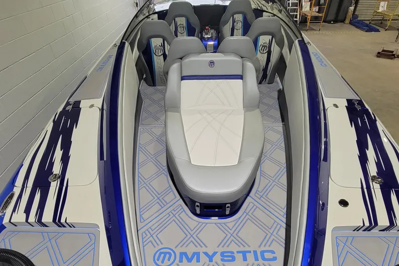 Slide: The Image of 2022 Mystic Powerboats C4000 interior with sleek seating and modern design. - 16
