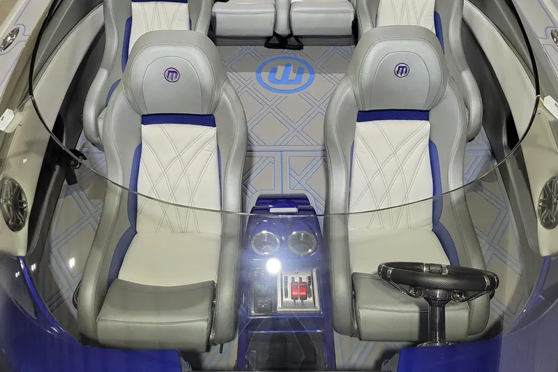 Slide: The Image of 2022 Mystic Powerboats C4000 interior with luxury seating and modern controls. - 18