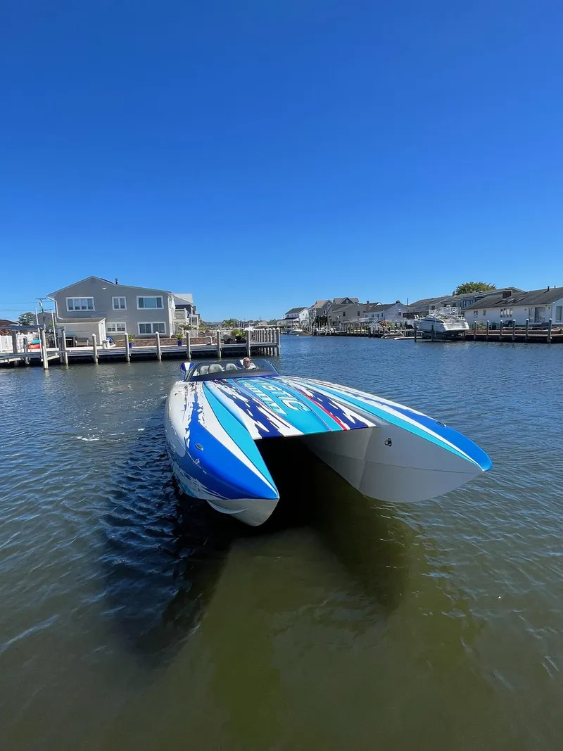 Slide: The Image of 2022 Mystic Powerboats C4000 catamaran on a sunny waterfront. - 8
