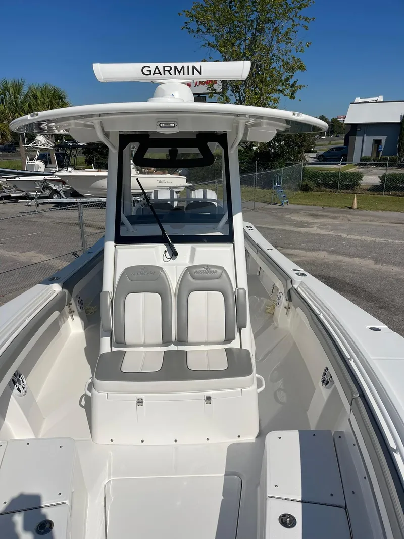 Slide: The Image of 2022 Regulator 31 boat with Garmin radar, white seating, and sleek design. - 10
