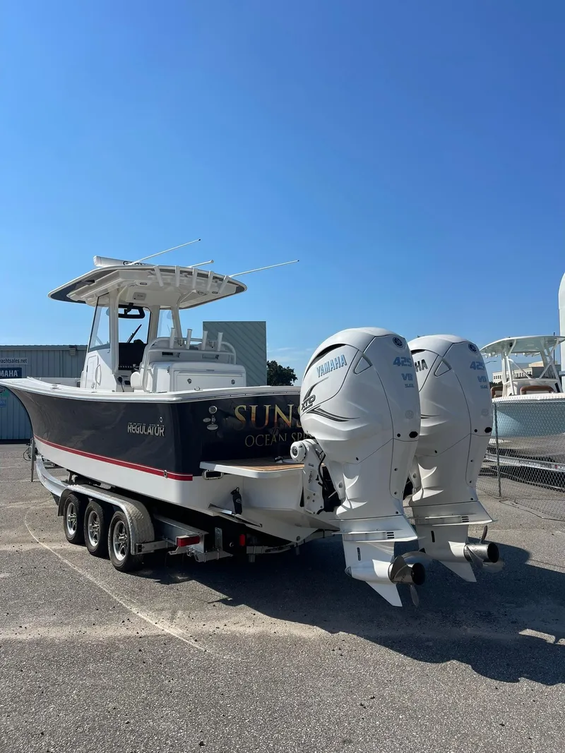 Slide: The Image of 2022 Regulator 31 boat with dual outboard engines on a trailer. - 3