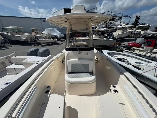 Slide: The Image of 2015 Grady-White Fisherman 257 boat at marina, clear sky, multiple boats in background. - 13