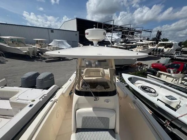 Slide: The Image of 2015 Grady-White Fisherman 257 boat in a marina, surrounded by other vessels. - 14