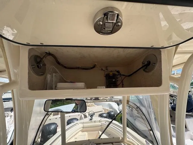 Slide: The Image of 2015 Grady-White Fisherman 257 boat console interior with wiring and storage. - 23