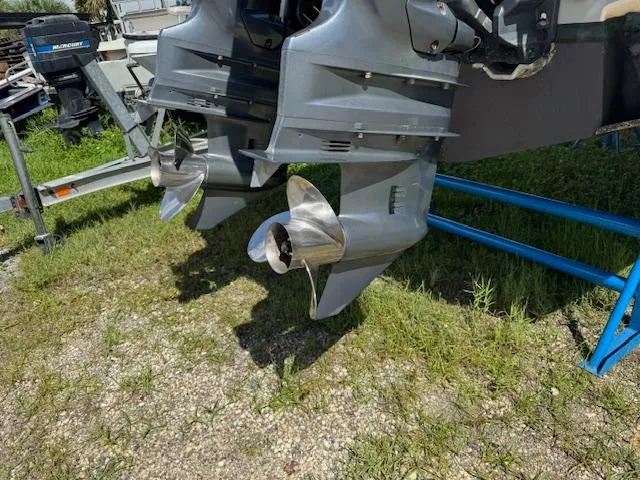 Slide: The Image of Twin outboard motors on a 2015 Grady-White Fisherman 257 boat, parked on grass. - 34